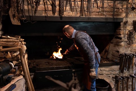 An elderly blacksmith in Salzburg, Austria, preserves the centuries-old craft of blacksmithing,