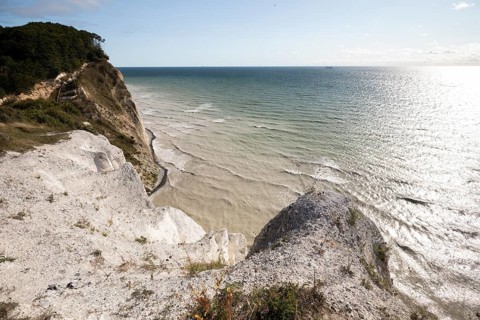 Chalk cliffs at Hundevængsfald with a stormy Baltic Sea, the water milky with chalk sediment, under