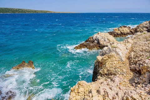 Romantic view over the sea in Koromacna Bay on a sunny day with rough seas on the island of Cres,