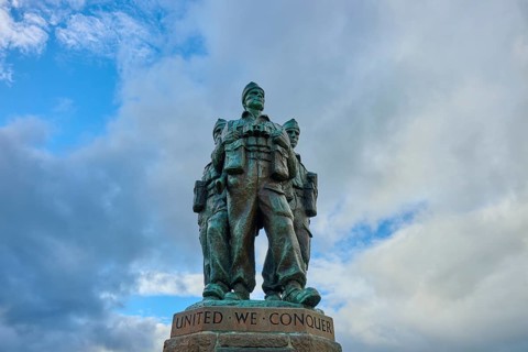 Bronze statue of soldiers surrounded by clouds with the phrase 'United We Conquer', Commando