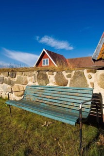 Park bench, bench, wooden bench in front of a wooden house in Karlskrona, Sweden