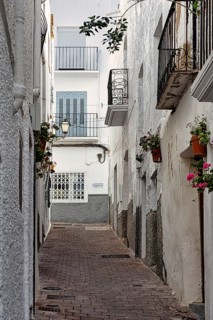 Typical narrow alley with small balconies, old town of Mojácar, Almería, Andalucia, Spain