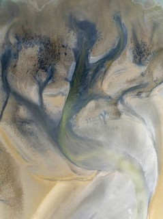 Streams and marshes at low tide in the wetlands of the Walvis Bay lagoon. In the distance Greater