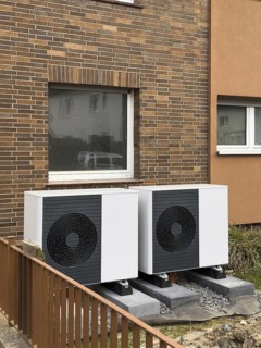 2 heat pumps are installed on an apartment block in a front garden, Hilden, Germany