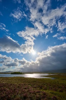 Natural landscape with clouds in front of the sun and river in the foreground, Rannoch Moor, Bridge