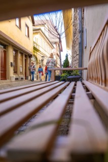 Perspective of a bank with people on a city alleyway, Schwäbisch Hall, Germany