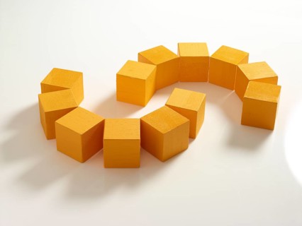 12 yellow wooden cubes against a white background
