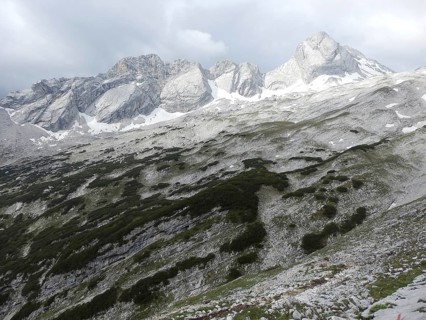 Rocky mountain landscape in the Alps with snow-capped peaks and clouds, hiking through the Reintal