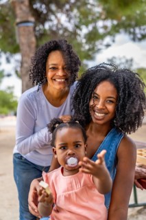 Portrait of happy african family of three generation woman in the park