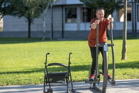 An individual with special needs enjoys an outdoor exercise session at a mental handicap day center
