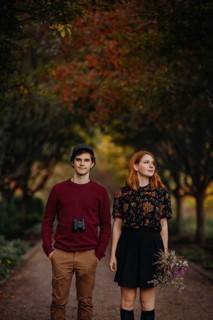 A couple takes a leisurely stroll through a picturesque path in Quebec during autumn. The