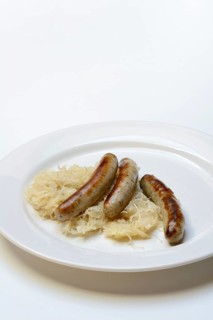 Nuremberg sausages with sauerkraut on a plate, Rostbratwurst, Germany