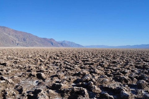 Rough, irregular salt formations in an extensive desert landscape, Devil's Golf Course, Badwater,