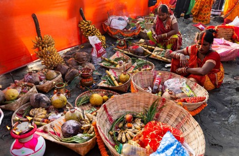 Hindu devotees gather on the banks of the Brahmaputra River to offer prayers to the Sun God on the