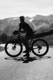 Road bike rider in spring near Halblech in the Allgäu in front of a picturesque backdrop of the