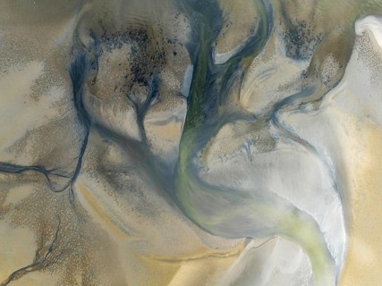Streams and marshes at low tide in the wetlands of the Walvis Bay lagoon. In the distance Greater