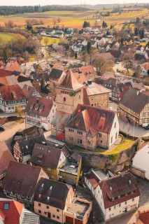 Historic old town with half-timbered houses and a church in the center from a bird's eye view,