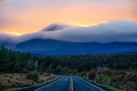Mount Ngauruhoe in the morning at sunrise with glowing clouds, road SH 47. Tongariro National Park,