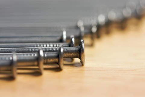 Macro of Nails on a Wood Background