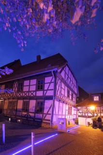 Leaning house with artificial lighting, half-timbered house, blue hour, twilight, night view, light