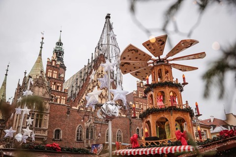 Christmas fair in the market square of Wroclaw, Poland. The city hall and wind mill