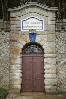 Portal with city coat of arms, door and entrance to the Schläferskopfstollen, inscription, bunker,
