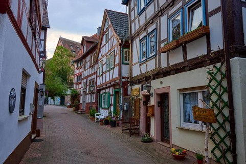 A charming paved street lined with half-timbered houses with flowers and a closed atmosphere, spa
