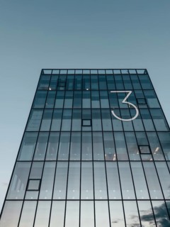 Corporate building with glass facade and a big number 3