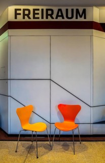 Colourful wooden chairs in the sixties style in a room in the Museum of Communication on Leipziger