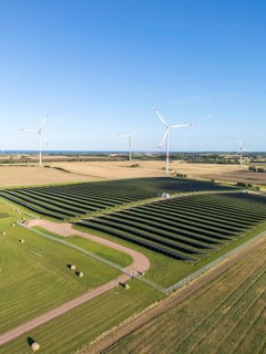 Wind farm and solar cells renewable energy wind power wind energy on the Baltic Sea aerial view