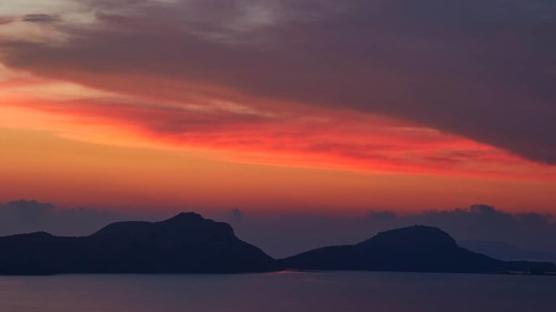 Sunset over sea with islands and red sky, Navarino Bay, Pylos, Peloponnese, Greece