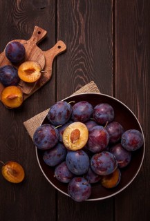 Blue plum, on a wooden table, top view, close-up, no people