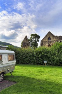 Caravan with retractable roof in a meadow, retro, cult, ruin, campsite, Abbey Farm, Llangollen,