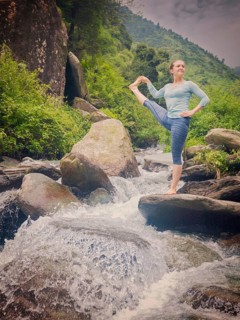 Yoga outdoors, woman doing Ashtanga Vinyasa Yoga balance asana Utthita Hasta Padangushthasana,