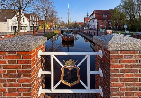 City coat of arms with open-air shipping museum on the main canal, museum ship Frisian Tjalk Thekla