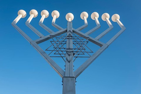 Large Hanukkah chandelier at the Brandenburg Gate in daylight, sign of lively Jewish life, symbolic