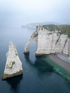 Aerial view of La Porte d'Aval and l'Aiguille on the Alabaster Coast in light fog, Etretat,