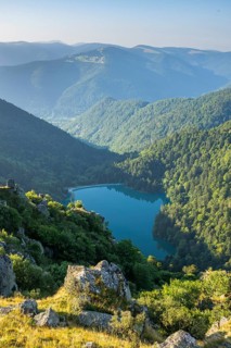 Water reservoir down in the valles on a sunny morning from Mount Hohneck in the Vosges Mountains,