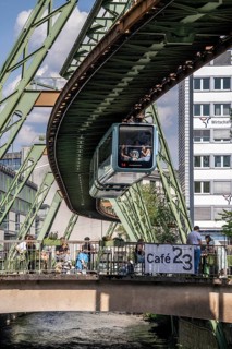 Train of the Wuppertal suspension railway runs along the Wupper, at the main station stop, terrace