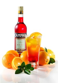 Cocktail Campari Orange on ice cube cubes in a long drink glass in front of a white background,