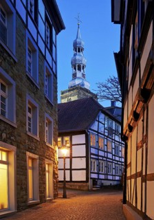 Mariengasse in the old town with half-timbered houses and St Peter's Church in the evening, Soest,