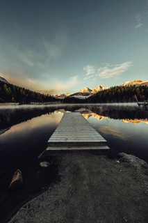 Lake Staz near Sankt Moritz in the Engadin in Switzerland. Morning atmosphere with fog in autumn.