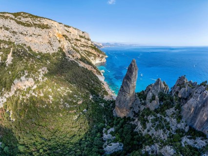 Picturesque rocky coast, cliffs with L'Aguglia pinnacle, blue sea and Cala Goloritzé beach, aerial