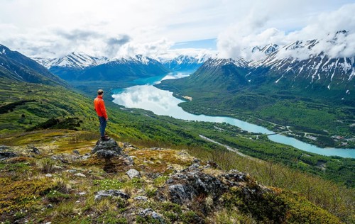 Climber enjoying the view, Slaughter Ridge Trail, view of snowy mountains and turquoise blue Kenai