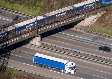 Freight train crosses the A42 motorway at Oberhausen-Zentrum on a railway bridge, the railway line