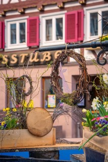 Easter decoration with flowers and wreath on a village square in front of half-timbered houses,