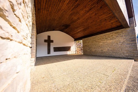 Stone wall with cross, quiet and shady architectural scene, Gechingen, Calw district, Germany