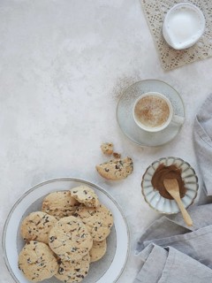 Table set with homemade cookies and hot cinnamon milk drink. Top view with copy space