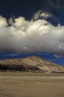 Beach landscape with dunes and clouds under a clear blue sky, Pajara, Fuerteventura, Canary