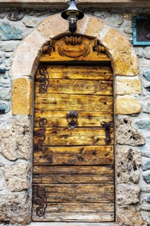 Old decorated wooden entrance door, historic village centre, Grimentz, Val d'Anniviers, Valais